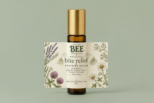 An amber glass bottle with a metallic gold cap and a detailed botanical label for 'Vitamin Bee Wellness Co. Botanical Bite Relief Soothing Roller', set against a solid sage green background.